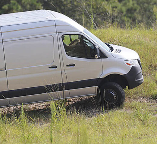 A Mercedes-Benz Adventure Van driving up a steep hill with all-wheel drive. 