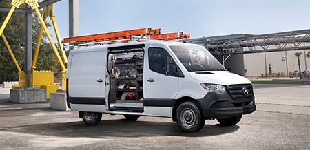 A Mercedes-Benz van that is upfitted for a builder.