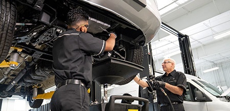 Mechanic working on Mercedes-Benz van.