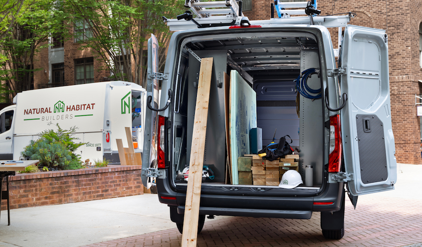 View of a Mercedes-Benz Sprinter Van, back open.